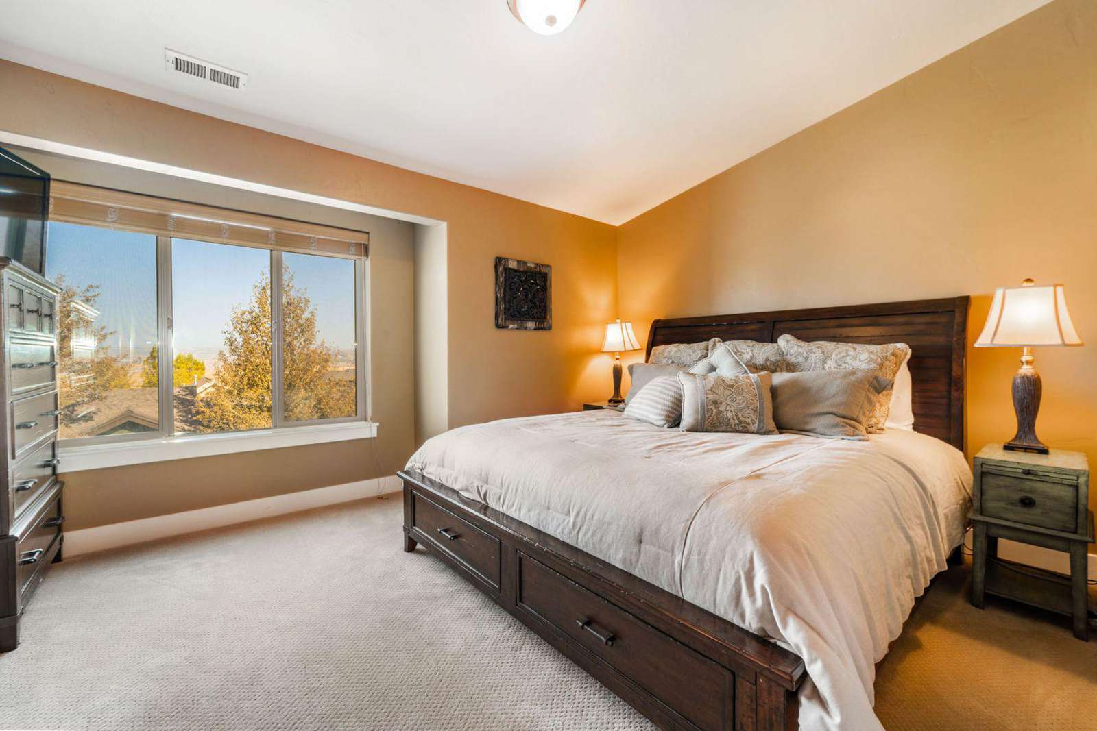 Guest bedroom with dresser and TV
